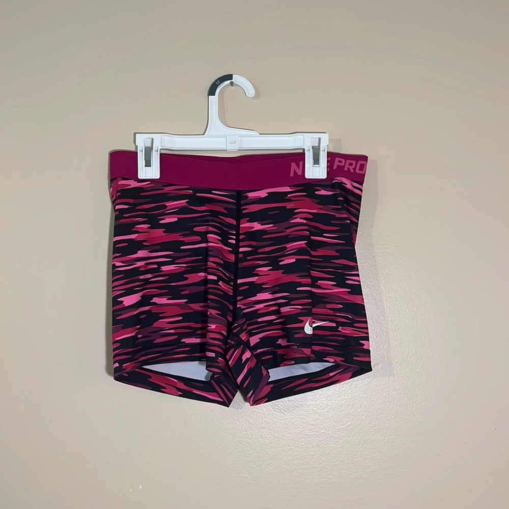 Pink and black patterned nike pros size large.